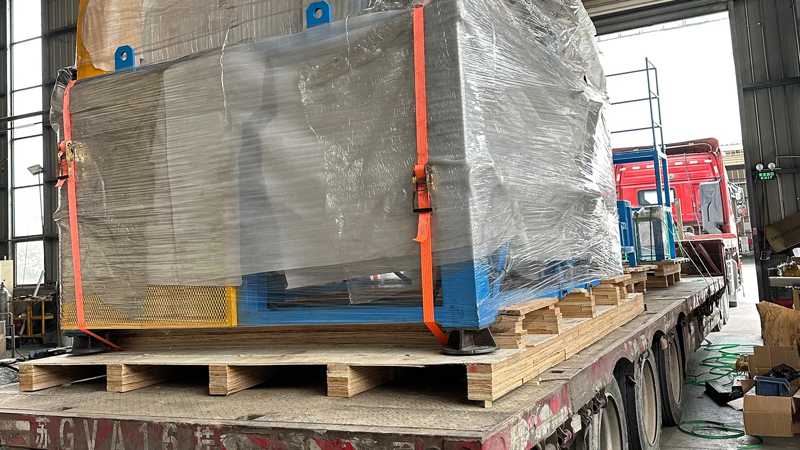 Import from China to Thailand: cargo strapped to a flatbed truck for the port